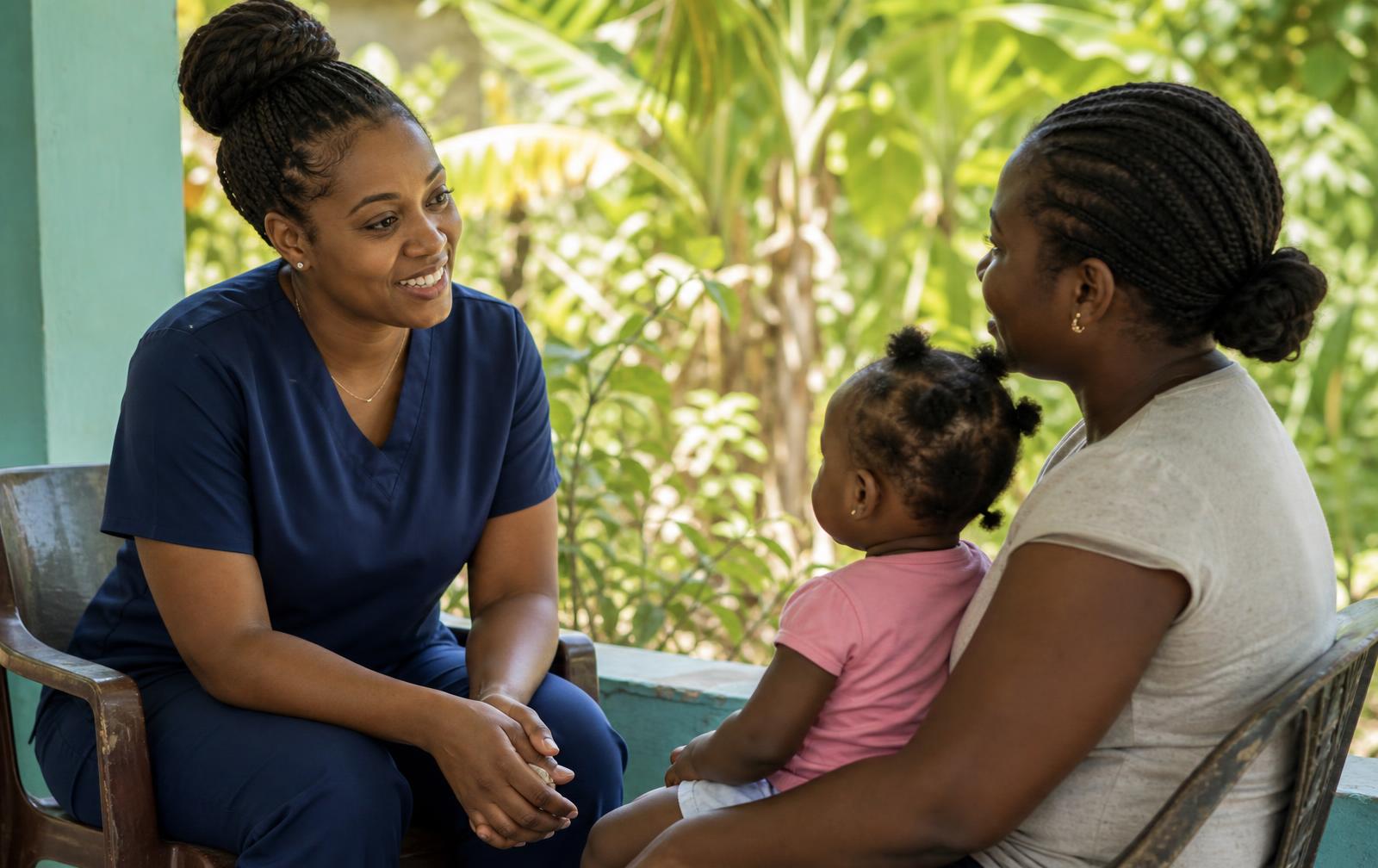 A community health nurse talking with a mother and her young child outside a health centre